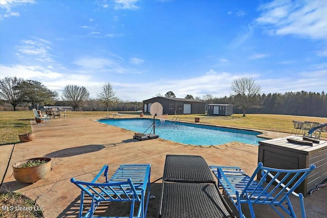 view of pool featuring a patio and a storage unit