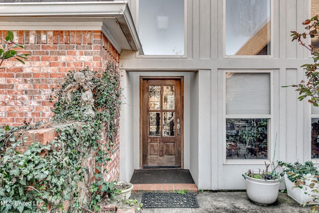 property entrance featuring brick siding