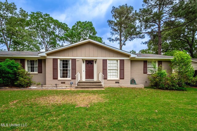 single story home with board and batten siding, crawl space, a front lawn, and brick siding