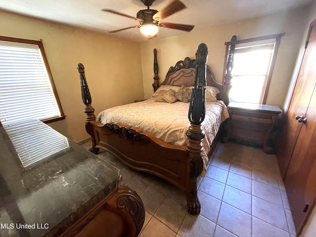 tiled bedroom with ceiling fan