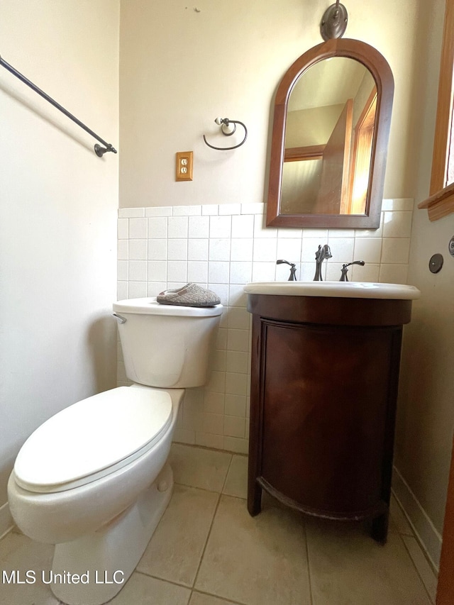 bathroom with tile walls, tile patterned flooring, vanity, and toilet