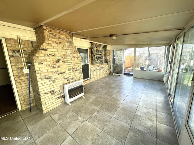 unfurnished sunroom featuring heating unit