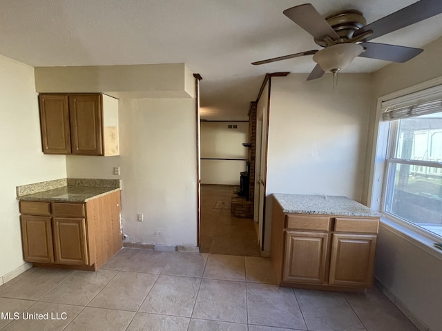 kitchen with ceiling fan and light tile patterned floors