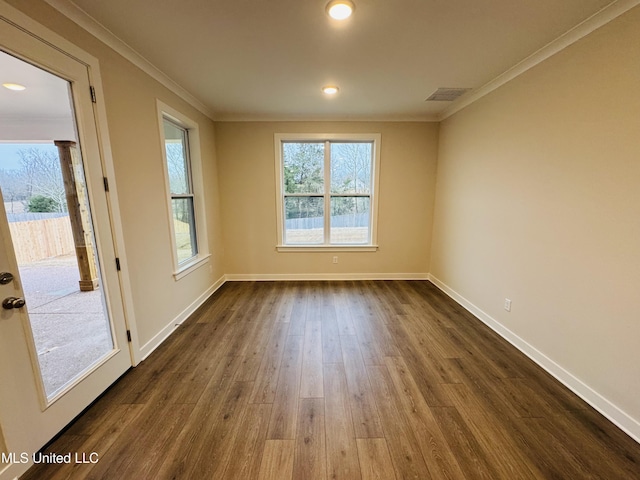 spare room with dark wood-style floors, crown molding, baseboards, and recessed lighting