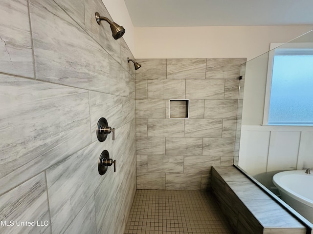 full bath featuring a tile shower