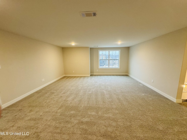 unfurnished room with carpet flooring and baseboards
