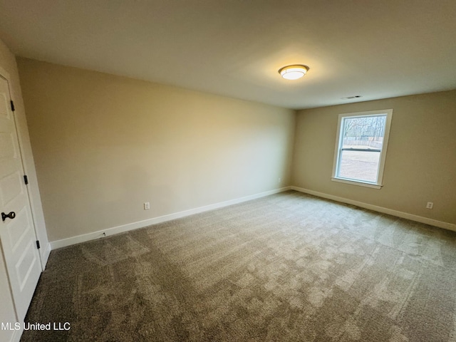 carpeted spare room with baseboards