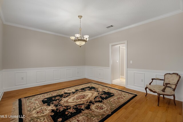 95 Sweet Bay Trl, Petal, MS 39465 - empty room featuring a chandelier, ornamental molding, light wood finished floors, and wainscoting