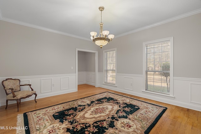 95 Sweet Bay Trl, Petal, MS 39465 - sitting room with ornamental molding, a chandelier, light wood finished floors, and a wainscoted wall