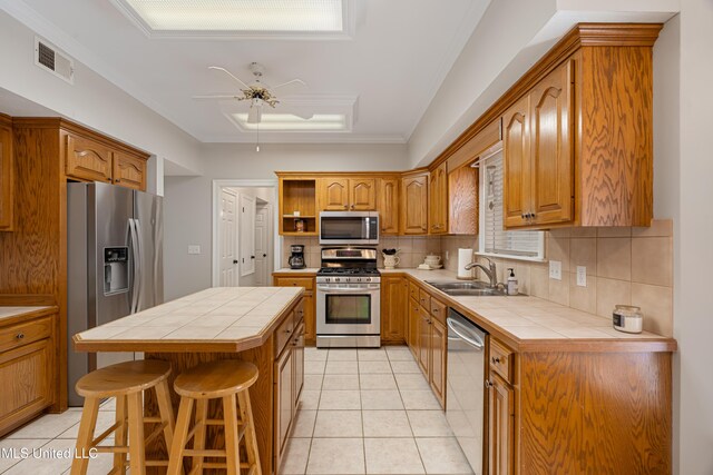 95 Sweet Bay Trl, Petal, MS 39465 - kitchen with appliances with stainless steel finishes, tile counters, ceiling fan, open shelves, and decorative backsplash