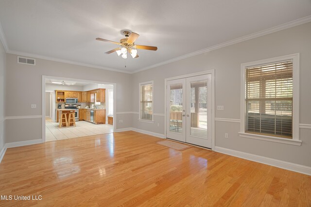 95 Sweet Bay Trl, Petal, MS 39465 - unfurnished living room with french doors, a ceiling fan, plenty of natural light, light wood-style flooring, and ornamental molding