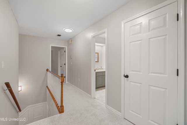 95 Sweet Bay Trl, Petal, MS 39465 - hallway featuring an upstairs landing, light colored carpet, a sink, and baseboards