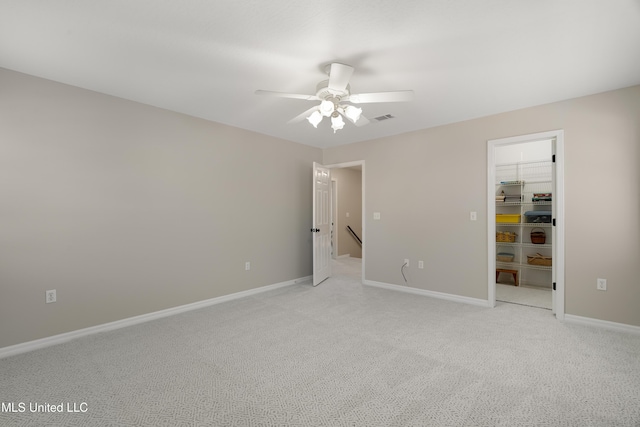 95 Sweet Bay Trl, Petal, MS 39465 - unfurnished bedroom featuring a spacious closet, light carpet, baseboards, a closet, and a ceiling fan
