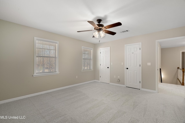 95 Sweet Bay Trl, Petal, MS 39465 - unfurnished bedroom with light colored carpet, baseboards, multiple closets, and ceiling fan