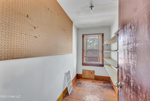 hallway with baseboards and wood-type flooring