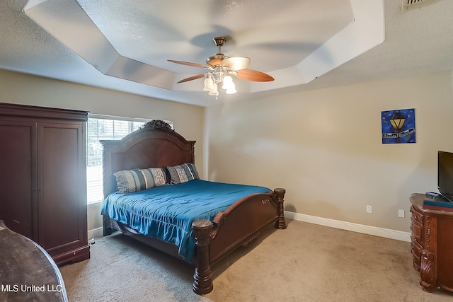 152 Sycamore Dr, Pass Christian, MS 39571 - carpeted bedroom featuring a tray ceiling, baseboards, a ceiling fan, and a textured ceiling