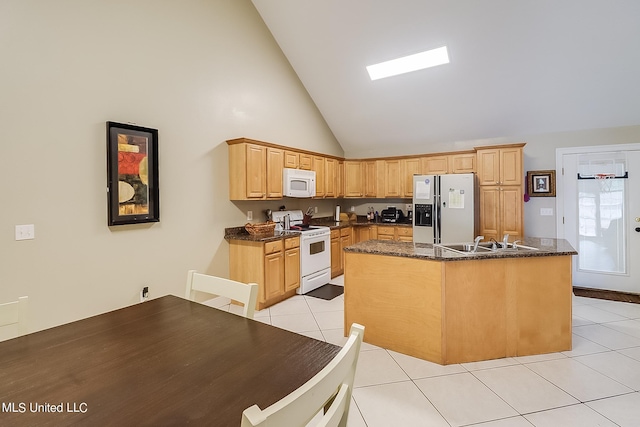 152 Sycamore Dr, Pass Christian, MS 39571 - kitchen featuring white appliances, light tile patterned floors, a sink, an island with sink, and light brown cabinetry