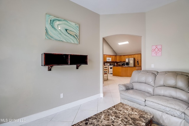 152 Sycamore Dr, Pass Christian, MS 39571 - living room featuring light tile patterned floors, vaulted ceiling, and baseboards