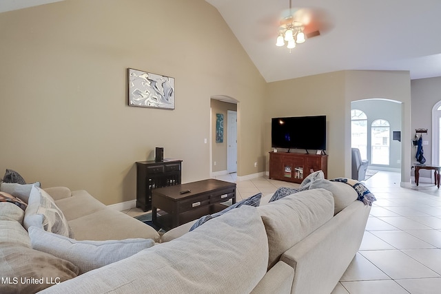 152 Sycamore Dr, Pass Christian, MS 39571 - living area featuring arched walkways, a ceiling fan, light tile patterned floors, high vaulted ceiling, and baseboards
