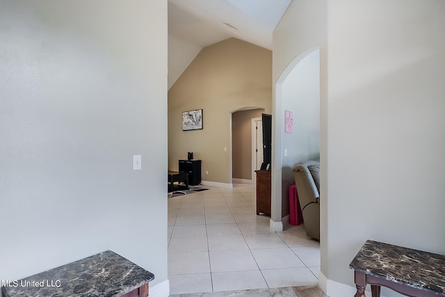 152 Sycamore Dr, Pass Christian, MS 39571 - hall with arched walkways, light tile patterned floors, baseboards, and high vaulted ceiling