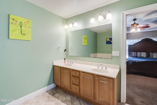 152 Sycamore Dr, Pass Christian, MS 39571 - full bath featuring ceiling fan, baseboards, double vanity, and ensuite bathroom
