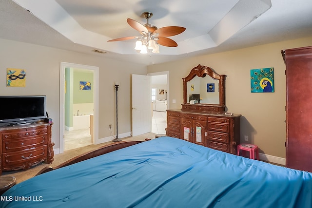 152 Sycamore Dr, Pass Christian, MS 39571 - bedroom with a tray ceiling, carpet flooring, baseboards, and connected bathroom