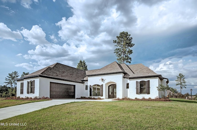 100 Grayson Way, Madison, MS 39110 - french country style house with concrete driveway, a front yard, stucco siding, french doors, and a garage