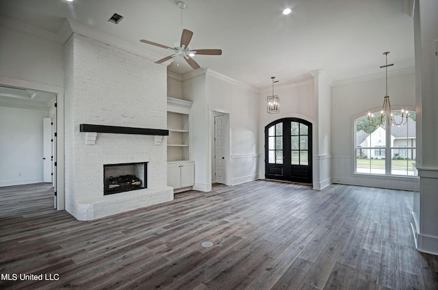 100 Grayson Way, Madison, MS 39110 - unfurnished living room with crown molding, visible vents, dark wood-style flooring, a fireplace, and ceiling fan with notable chandelier