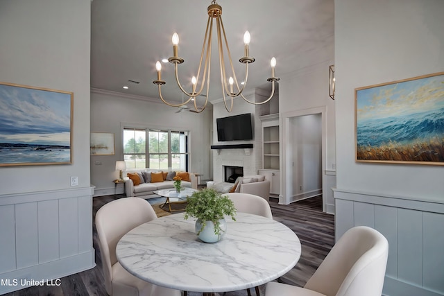 100 Grayson Way, Madison, MS 39110 - dining room featuring crown molding, an inviting chandelier, a fireplace, dark wood-type flooring, and built in shelves