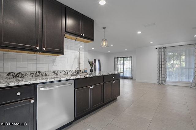 kitchen with pendant lighting, light tile patterned floors, dark brown cabinetry, decorative backsplash, and stainless steel dishwasher