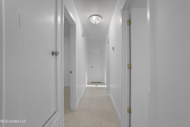 hall with light tile patterned floors