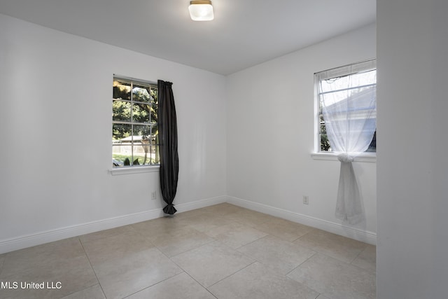 spare room featuring light tile patterned flooring