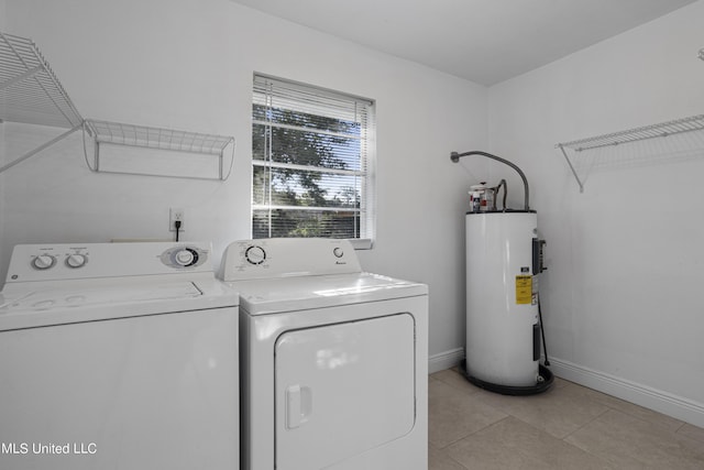 laundry area with independent washer and dryer, electric water heater, and light tile patterned floors