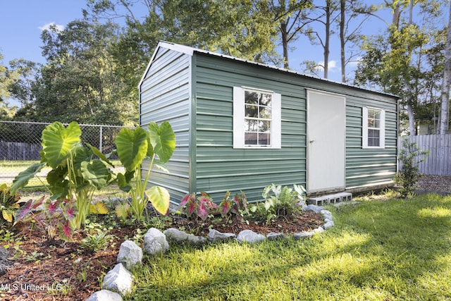 view of outbuilding featuring a yard