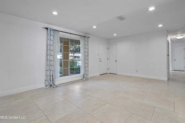 unfurnished room featuring light tile patterned floors