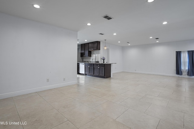 unfurnished living room with sink and light tile patterned floors