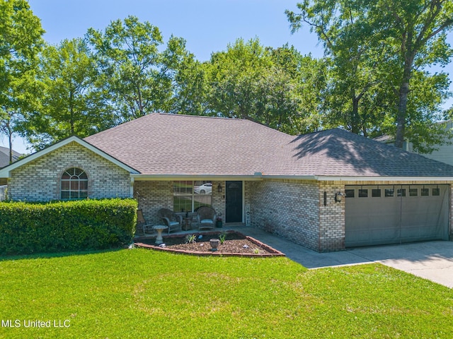 ranch-style home with brick siding, a front yard, and a garage