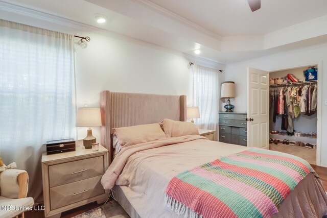 bedroom with recessed lighting, ornamental molding, a walk in closet, a closet, and ceiling fan