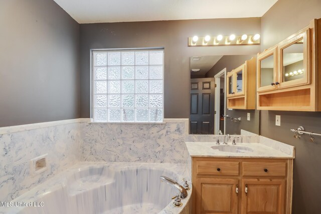 full bathroom with a garden tub and vanity