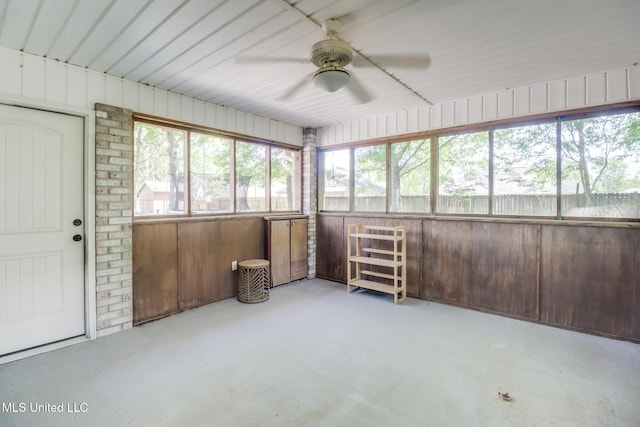 unfurnished sunroom featuring a ceiling fan