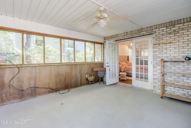 unfurnished sunroom with a ceiling fan