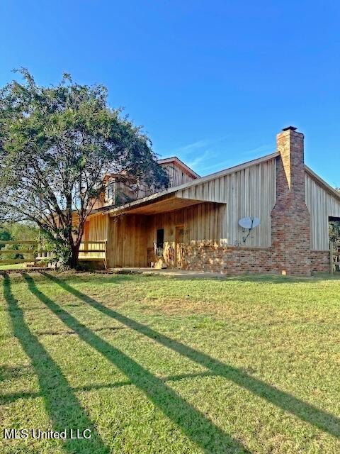 view of home's exterior featuring board and batten siding and a yard