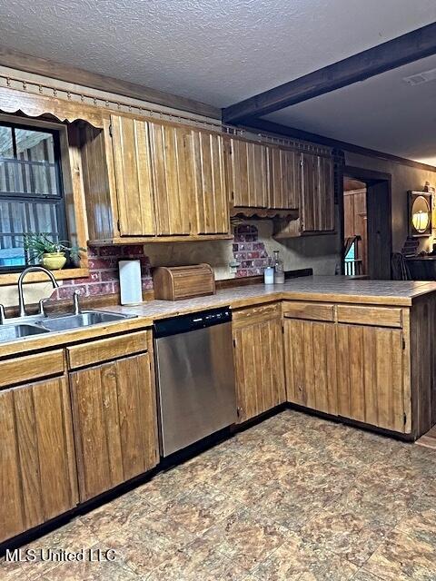 kitchen with stainless steel dishwasher, a peninsula, a textured ceiling, a sink, and brown cabinets