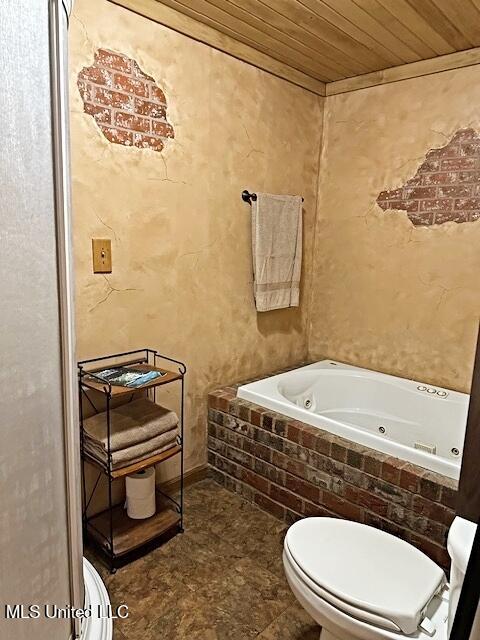 bathroom featuring toilet, wooden ceiling, and a jetted tub