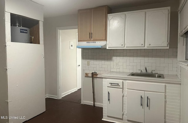 kitchen with white cabinetry, sink, tasteful backsplash, and water heater