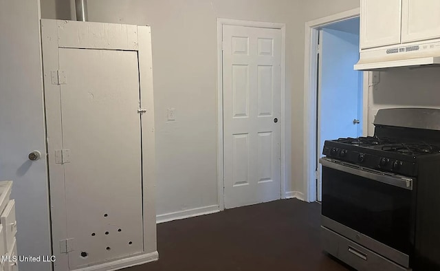 kitchen featuring gas stove and white cabinets