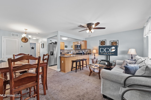 living room featuring visible vents, light carpet, and ceiling fan