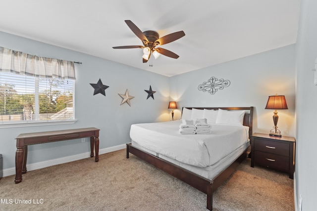 bedroom featuring light colored carpet, ceiling fan, and baseboards