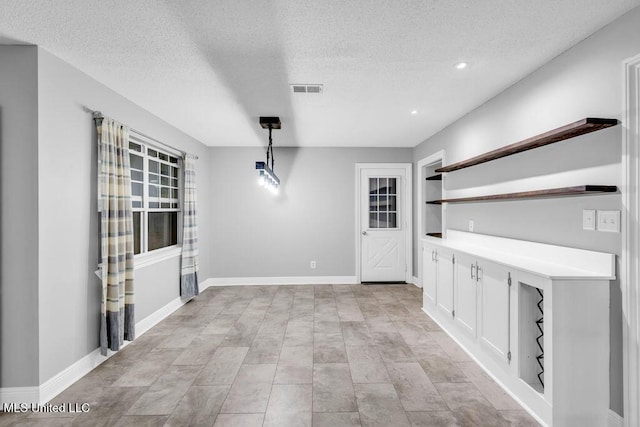 139 Booth Cir, Ocean Springs, MS 39564 - unfurnished dining area with a textured ceiling, built in features, and recessed lighting