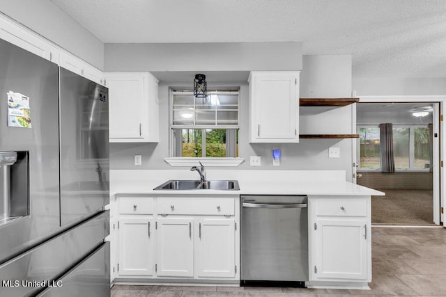 139 Booth Cir, Ocean Springs, MS 39564 - kitchen with appliances with stainless steel finishes, open shelves, white cabinets, a textured ceiling, and light countertops